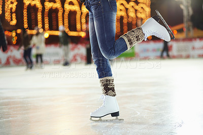 Buy stock photo Cropped shot of a young woman skating on an ice rink