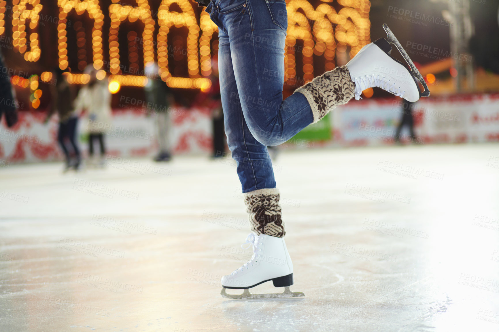 Buy stock photo Cropped shot of a young woman skating on an ice rink