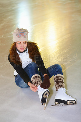 Buy stock photo Portrait, ice skating and woman tie shoes on rink to start fitness, exercise and workout at night. Skater, happiness and female person tying skates for winter training, getting ready and top view.