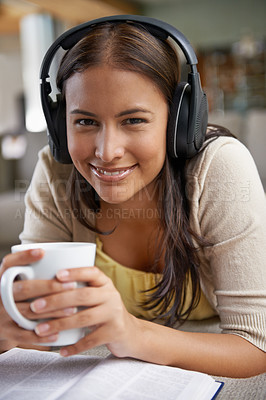 Buy stock photo Music, coffee and woman relax with a book on sofa in home on holiday, reading with a drink and happiness. Girl, smile and hearing sound from headphones on couch with free audio, novel and enjoy tea