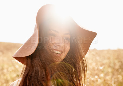 Buy stock photo Wheat, field and woman with happiness in sunlight for travel, fresh air and summer holiday with lens flare and hat. Person, face or smile in countryside with confidence, pride and laughing in nature 