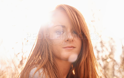 Buy stock photo Portrait, serious and woman in field with sunlight for travel, fresh air and summer holiday with lens flare outdoor. Person, face and ginger hair in countryside with confidence and pride in nature 