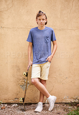 Buy stock photo Full-length shot of a teenage boy standing with his skateboard