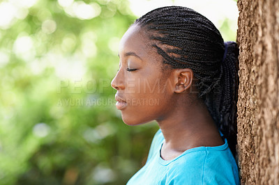 Buy stock photo Teen, girl and relax by tree outdoors, rest and peace in woods or forest on summer holiday. Black female person, nature and meditation in park or garden, calm and spiritual wellness in environment