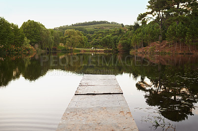 Buy stock photo Lake, pier and water with nature, sunshine and environment with trees and peace with summer. Empty, outdoor and reflection with countryside and bush with holiday and spring with river and calming