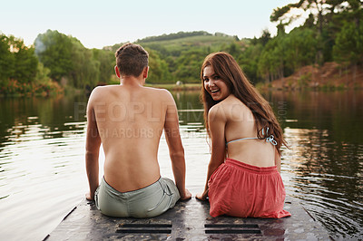 Buy stock photo Relax, portrait and couple on pier at lake together for happy holiday adventure in nature from back. Vacation, young woman and man at water with morning smile, summer and outdoor fun on dock at river