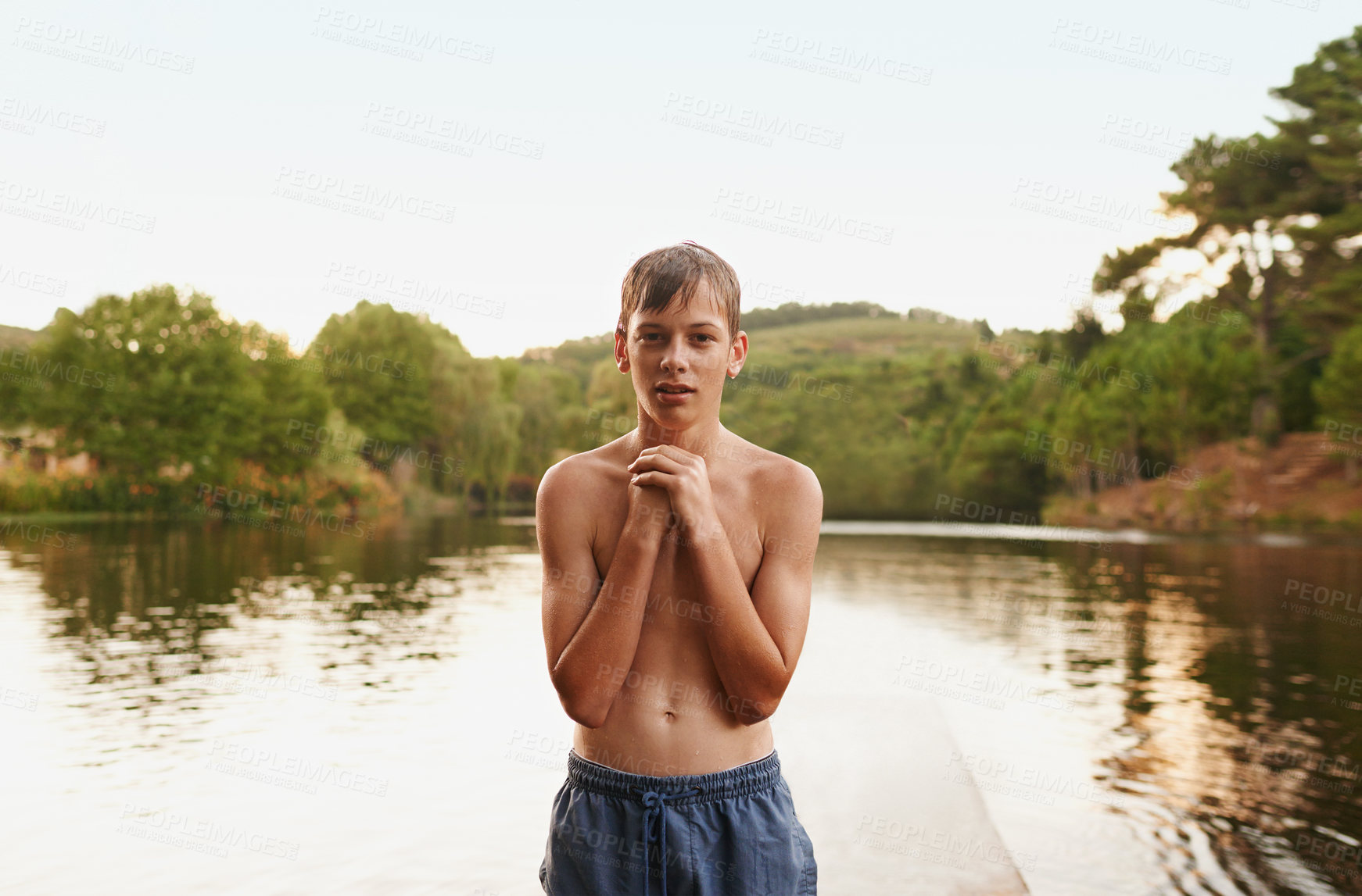 Buy stock photo Portrait, teenager and lake in nature swimming for adventure, summer vacation and sunshine. River, outdoor and face of male person on deck for holiday, getaway trip and fresh air in countryside