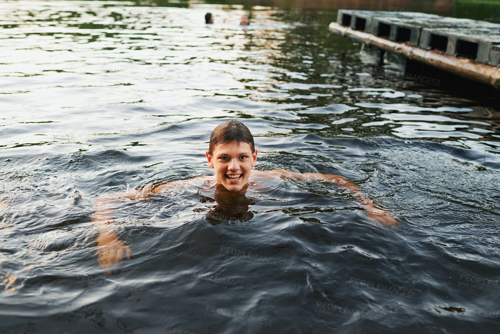 Buy stock photo Portrait, swimming and teenage boy with smile, lake and energy with weekend break and nature. Person, water and hobby with wellness and holiday with sunshine and wet with fresh air and getaway trip