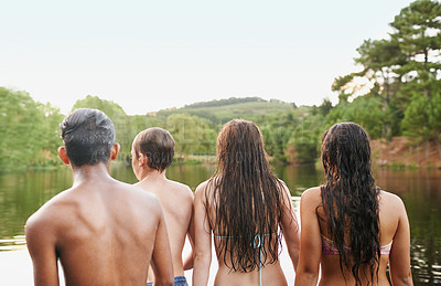 Buy stock photo Back view, diversity and friends together in lake, river and forest in countryside to relax for holiday, vacation or travel. Young people, group and outdoor with nature in water, swimming and on trip