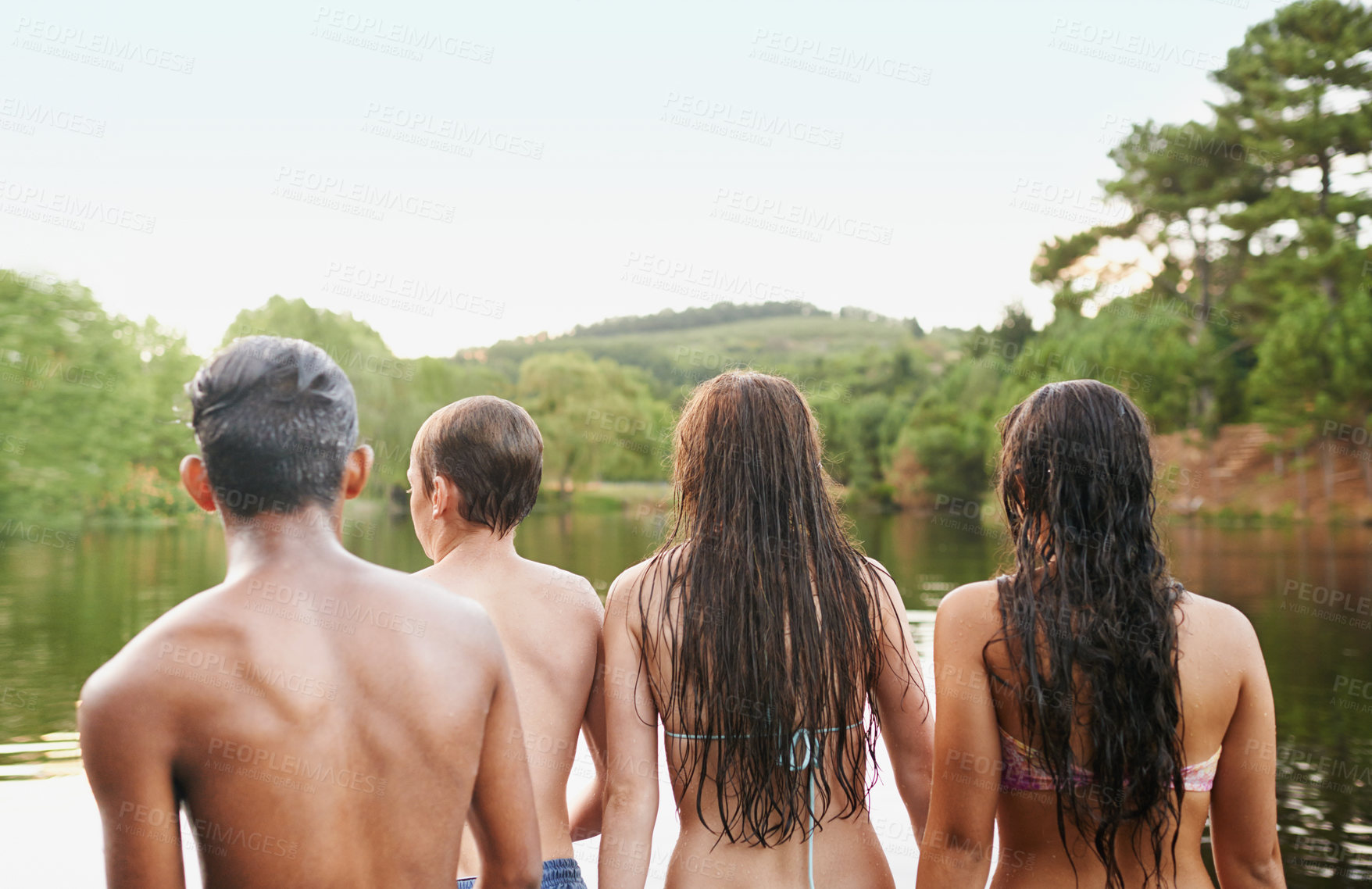 Buy stock photo Back view, diversity and friends together in lake, river and forest in countryside to relax for holiday, vacation or travel. Young people, group and outdoor with nature in water, swimming and on trip
