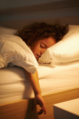 Buy stock photo Girl, sleeping and relax in bed at night, comfortable and tired or dream on pillow in home. Female person, child and resting in bedroom or lying for peace, exhausted and fatigue or blanket for calm