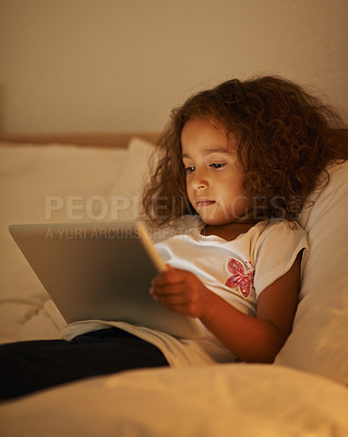 Buy stock photo App, child and tablet in bed at night, comfortable and online for games or playing in home. Female person, girl and movie in bedroom or lying to relax, website and internet or streaming entertainment