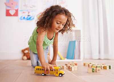 Buy stock photo Shot of a little girl playing with a toy truck and building blocks