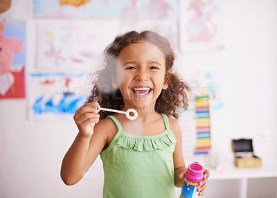 Buy stock photo Shot of an adorable little girl blowing bubbles in her bedroom