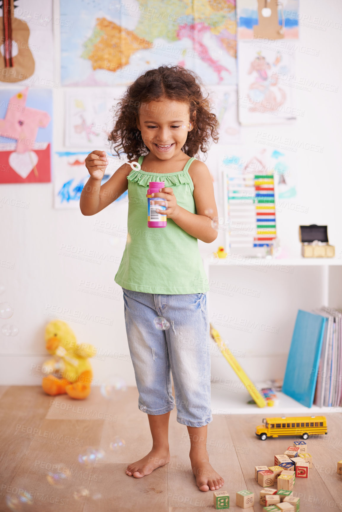 Buy stock photo Playing, kid and blowing bubbles with toys for childhood development, smile and having fun alone. Happiness, growth and face of young girl in kindergarten for learning, soap liquid and games
