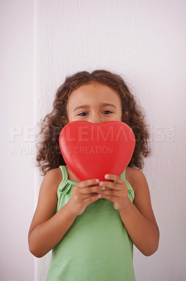 Buy stock photo Girl, child and portrait with heart for love in home, emoji and peace or kindness aesthetic with icon. Female person, valentines day and review or opinion by white background, compassion and care