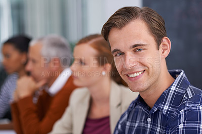 Buy stock photo A young businessman smiling while in a work meeting