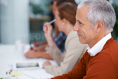 Buy stock photo Mature businessman, happy and listening to presentation in seminar and training with coworkers in conference room. Entrepreneur, smile or attention in convention for learning and workshop for skills