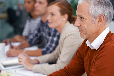 Buy stock photo Mature businessman, happy and training in presentation in seminar and attention with coworkers in conference room. Entrepreneur, smile or listening in convention for learning and workshop for skills
