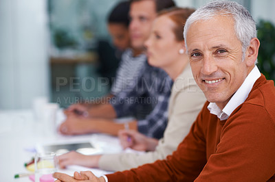 Buy stock photo Mature businessman, portrait and happy for training in seminar and meeting with coworkers in conference room. Accountant, positive or face in professional group or convention for finance or auditing