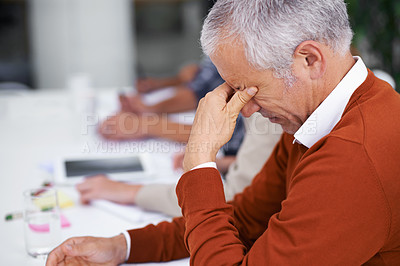 Buy stock photo Cropped shot of a mature businessman looking stressed