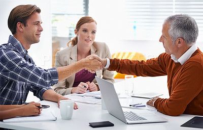 Buy stock photo A cropped shot of businesspeople shaking hands at a meeting