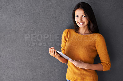 Buy stock photo Portrait, tablet and smile with woman in studio for streaming, social media and technology. Happiness, online shopping and webiste with face of femal person on wall background for interent blog