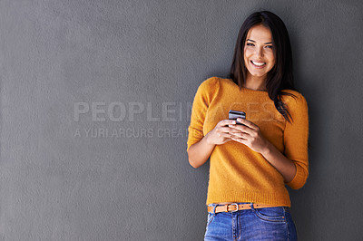 Buy stock photo Woman, phone and portrait for communication in studio, online and blog or reading notification. Female person, smile and scroll or browse on social media, gray background and internet for networking