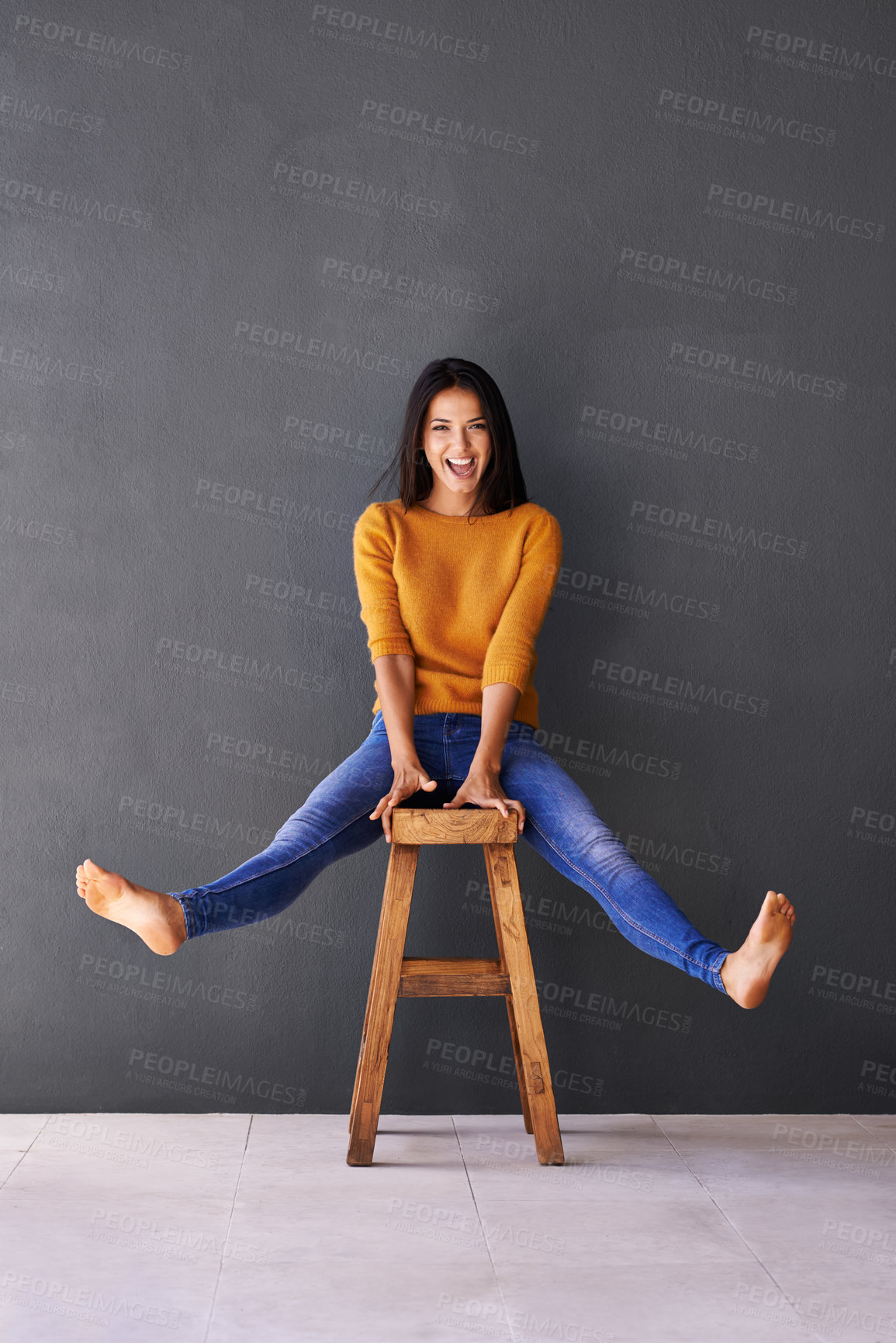 Buy stock photo Portrait, fashion and woman on chair in studio for excited, trendy or casual clothing with gray background. Happiness, cheerful and face of person on stool for wardrobe, sweater and stylish outfit