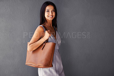 Buy stock photo Studio, portrait and handbag with fashion, joy and accessories with dress and smile. Woman, face and model with confidence, beauty and happiness with purse and style isolated on gray wall background