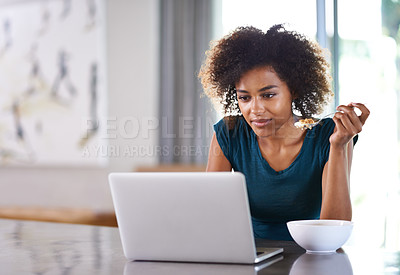 Buy stock photo Home, eating breakfast and woman on laptop for remote work, internet or social media at desk. Cereal, computer and African freelancer with food at table, nutrition and healthy diet in the morning