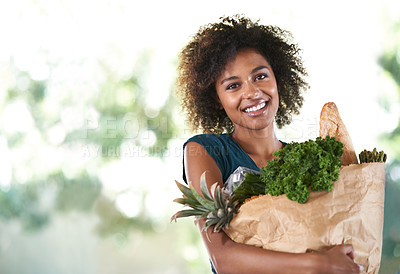 Buy stock photo Young girl smiling while holding her groceries - isolated