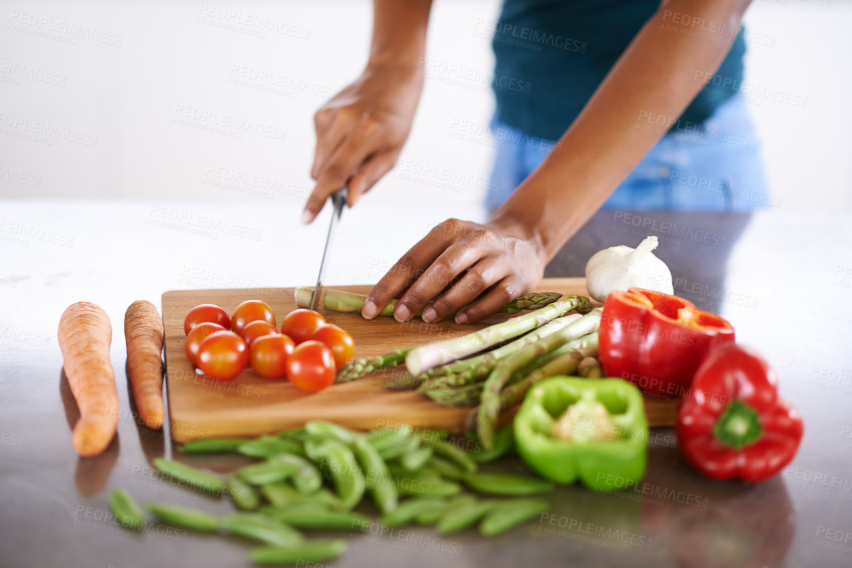 Buy stock photo Cropped closeup shot of a woman cutting up vegetables on a cutting board