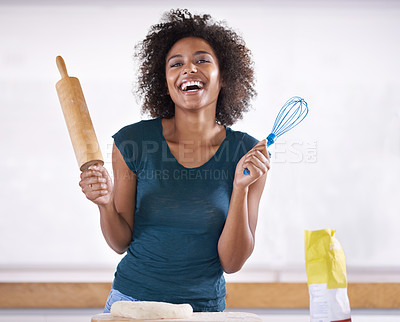 Buy stock photo Young woman preparing dough in her kitchen