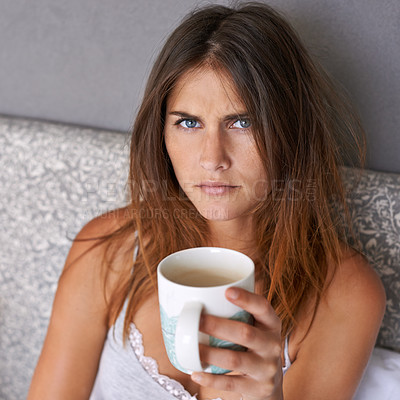 Buy stock photo Angry, woman and portrait with coffee in bed, frustrated and warm beverage for mental health in home. Lady, face and upset in bedroom with espresso cup and morning energy for burnout in apartment