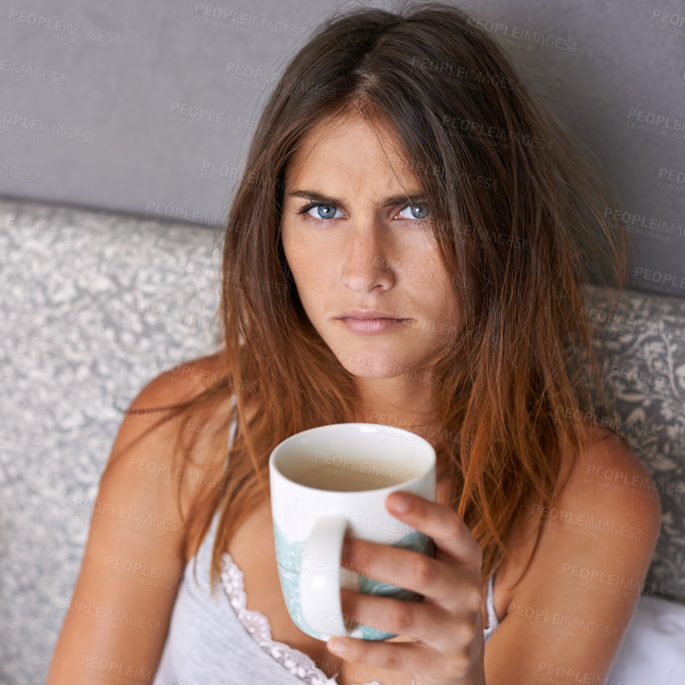 Buy stock photo Angry, woman and portrait with coffee in bed, frustrated and warm beverage for mental health in home. Lady, face and upset in bedroom with espresso cup and morning energy for burnout in apartment
