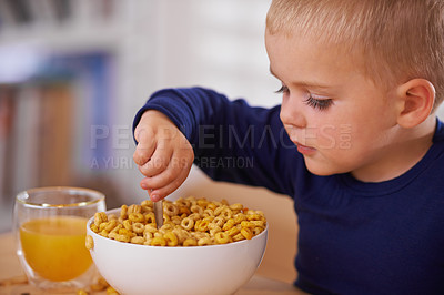 Buy stock photo Cropped shot of a young boy eating breakfast at home