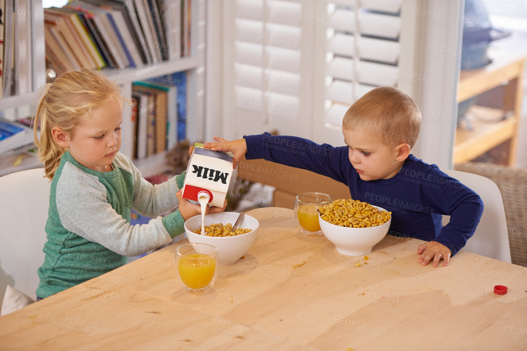 Buy stock photo Shot of a young brother and sister making breakfast at home