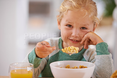 Buy stock photo Portrait of a cute little girl eating breakfast at home