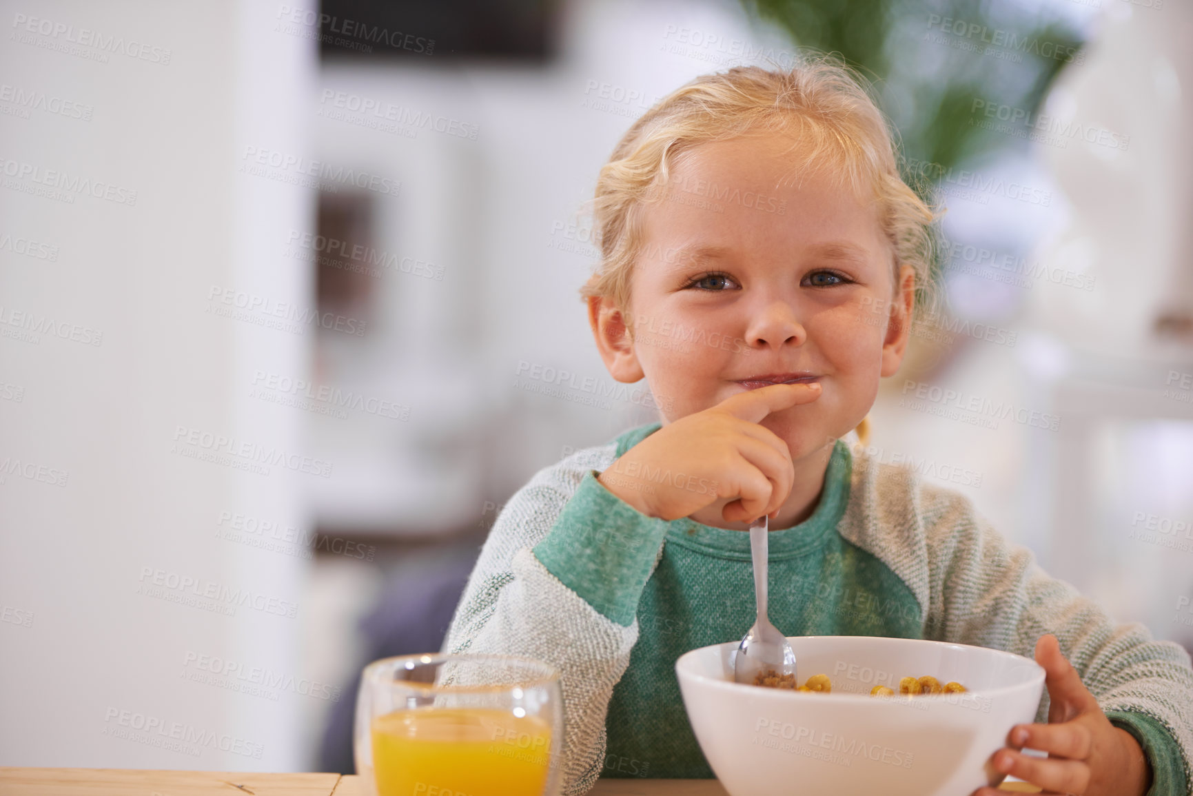 Buy stock photo Portrait, morning and a child eating breakfast with happiness, hungry and smile at a home table. Happy, young and a little girl smiling for food, cereal and enjoying a meal for nutrition in a house