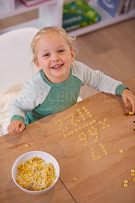 Buy stock photo Girl, cereal and play for fun in home, child and morning nutrition with table. Smart, math education with happy vitamins, fibre for toddler and healthy development for growing kid and food in bowl