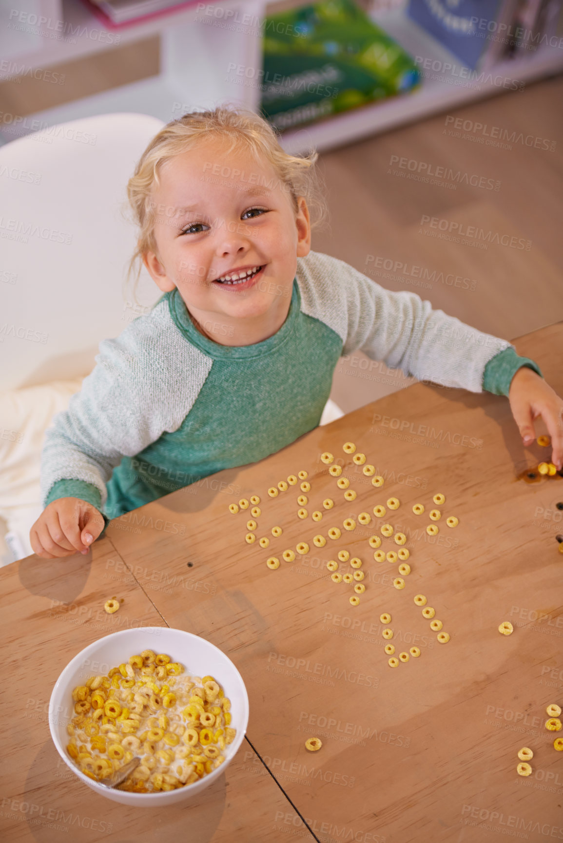 Buy stock photo Girl, cereal and play for fun in home, child and morning nutrition with table. Smart, math education with happy vitamins, fibre for toddler and healthy development for growing kid and food in bowl