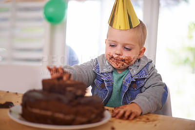 Buy stock photo Baby, birthday and eating cake in home, celebration for infant or party. Happy boy, dessert on table or excited cheerful event for growth with special decoration hat or messy face and childhood fun