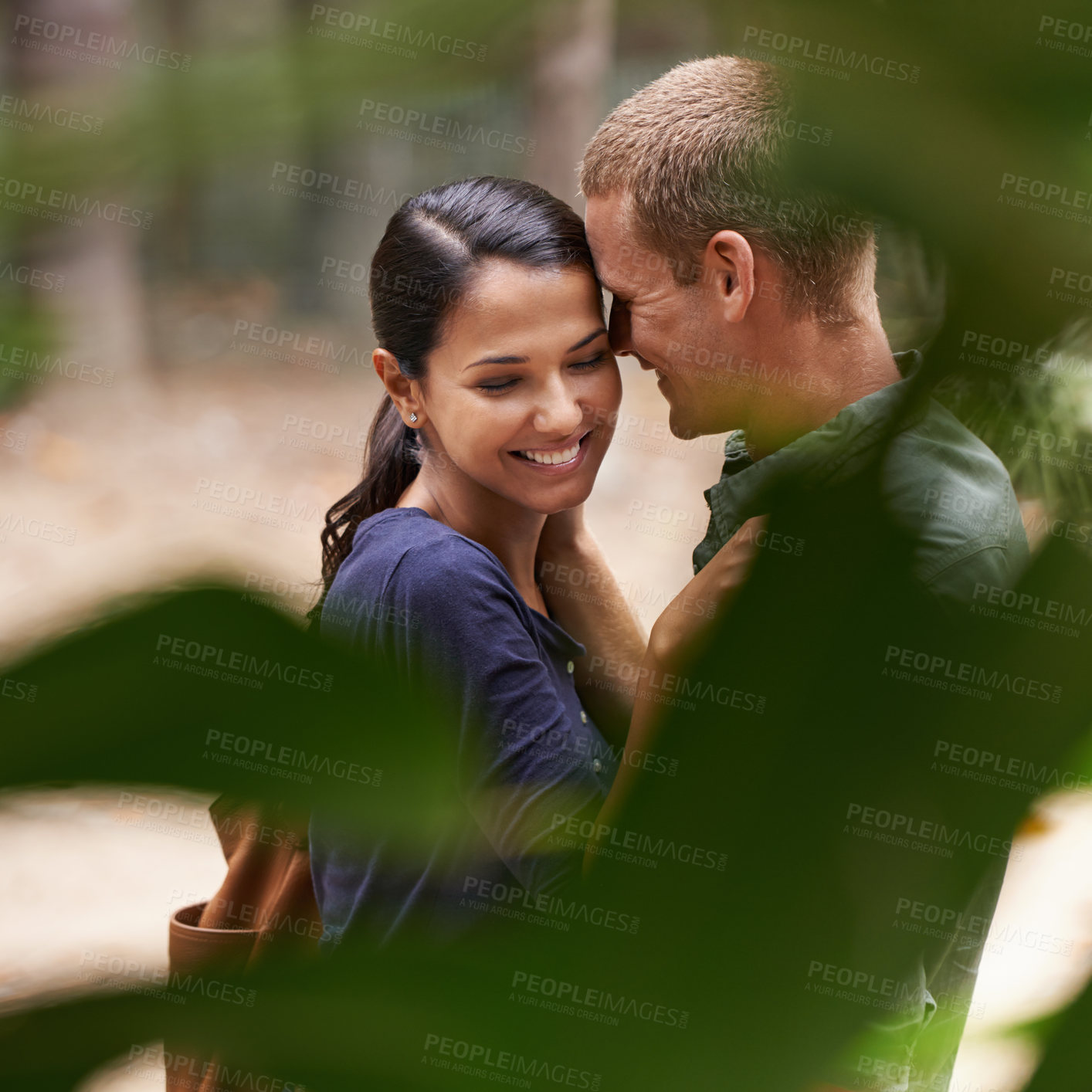 Buy stock photo Couple, hug and love or touch at park, relationship and care on outdoor adventure or holiday. People, plant and embrace on vacation and romance in nature, zoo and affection or date on weekend trip