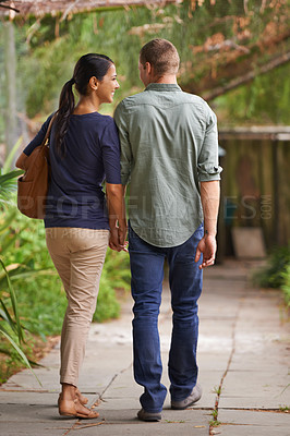 Buy stock photo Couple, holding hands and love or together in garden, relationship and care on outdoor adventure or holiday. People, back and walking on vacation and romance in park or zoo, date and calm or peace