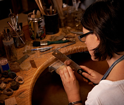 Buy stock photo Woodworking, artist and tools in hands at workshop with creative project or sculpture at night. Artisan, carpenter and woman with talent for creativity in dark studio in process of carving wood