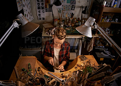 Buy stock photo Woodworking, tools and artist in workshop with creative project or above sculpture on table at night. Artisan, carpenter or person with talent for creativity in dark studio in process of carving wood