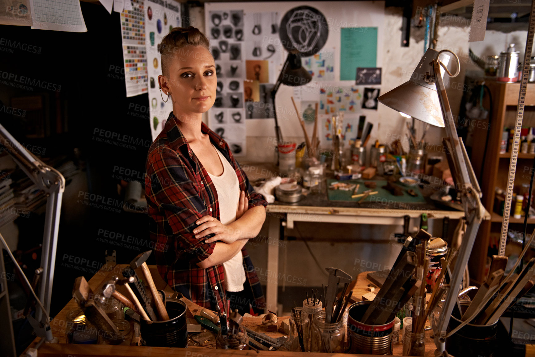 Buy stock photo Shot of a beautiful young woman sitting in a workshop