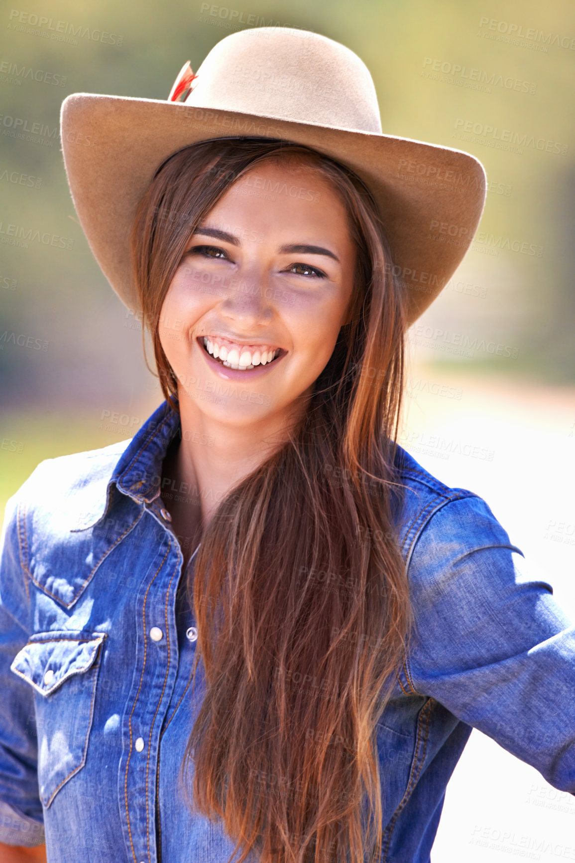 Buy stock photo Happy woman, portrait and cowgirl with hat for nature adventure, travel or outdoor journey in Texas. Young female person with smile in western fashion, denim shirt and cap at ranch in the countryside