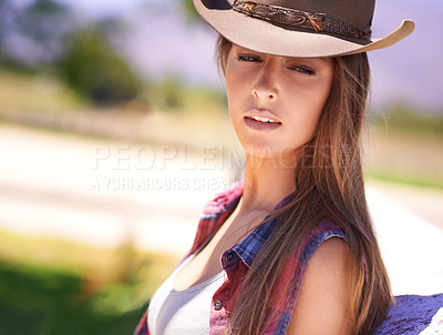 Buy stock photo Fashion, summer and cowgirl in hat on farm or ranch for agriculture or sustainability in countryside. Face, texas or western with young farmer leaning on fence in field organic or green farming